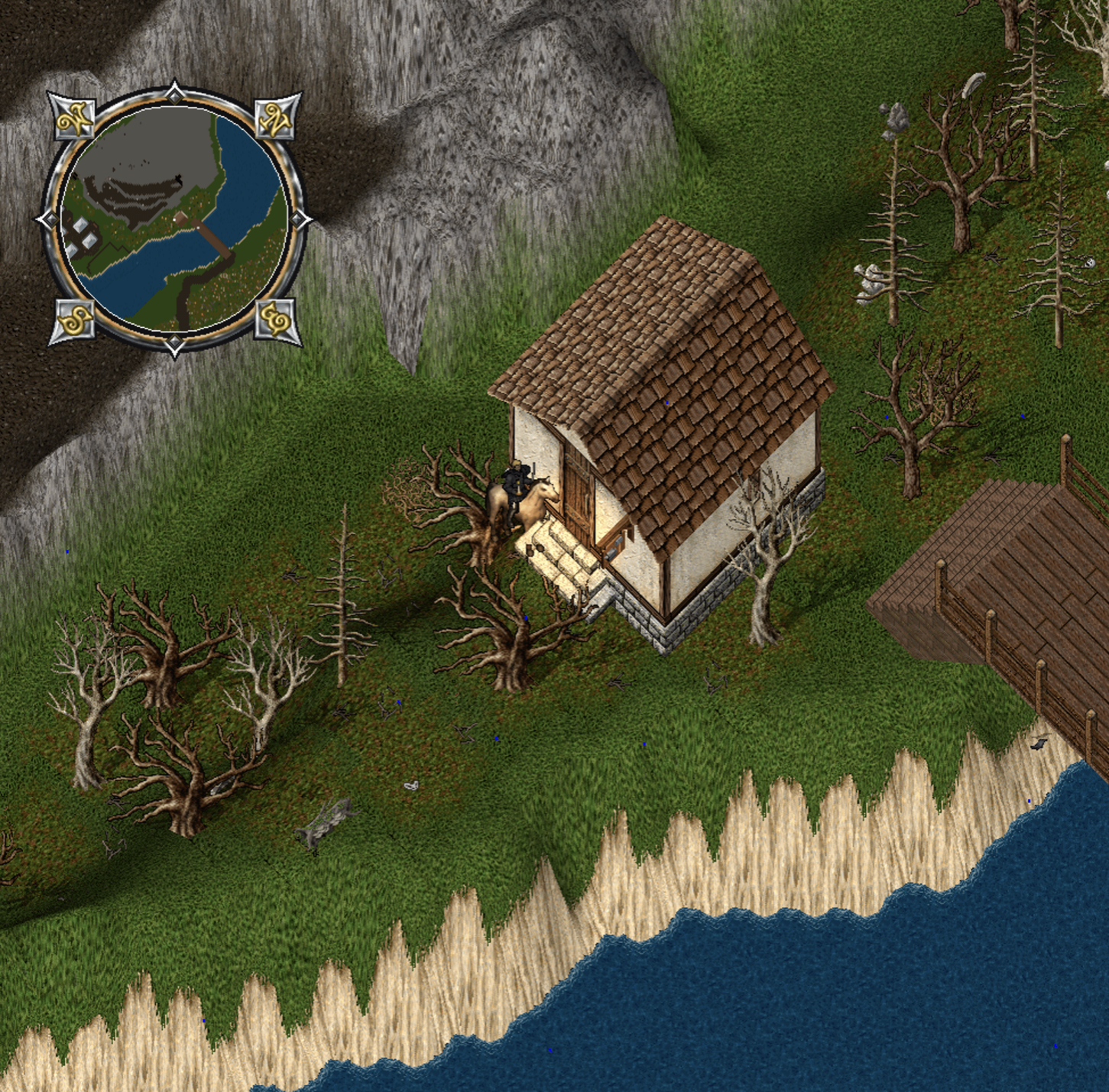 A screenshot of Ultima Online, showing a character riding a horse, standing in front of a  small single room house. The house sits between a bridge and a mountain cliff, with trees around it.