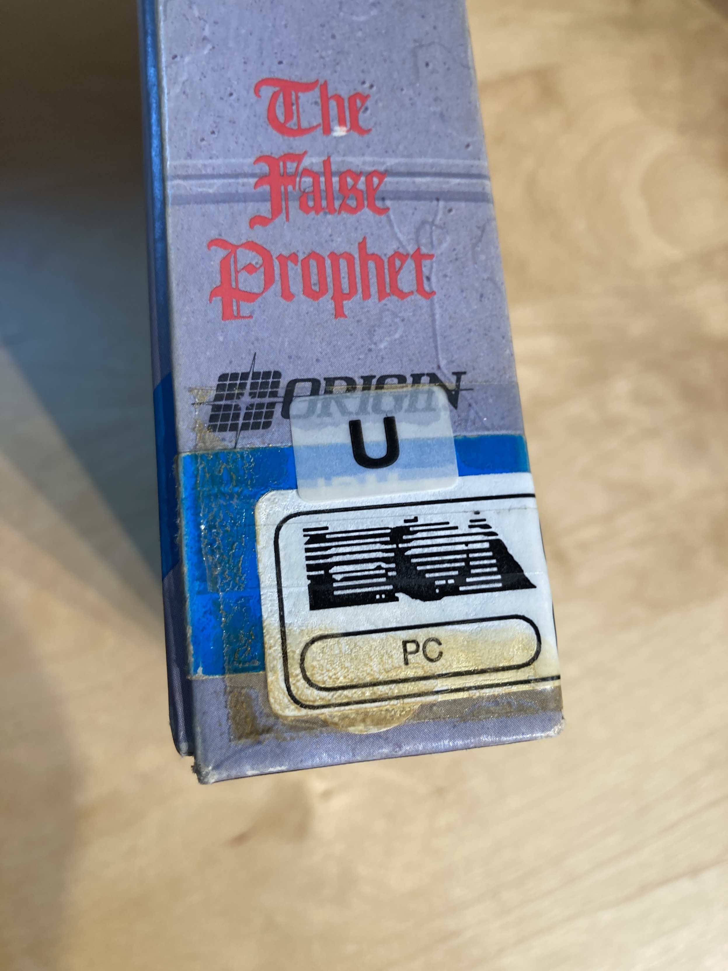 The spine of Ultima VI, showing an EA logo stickered overtop.