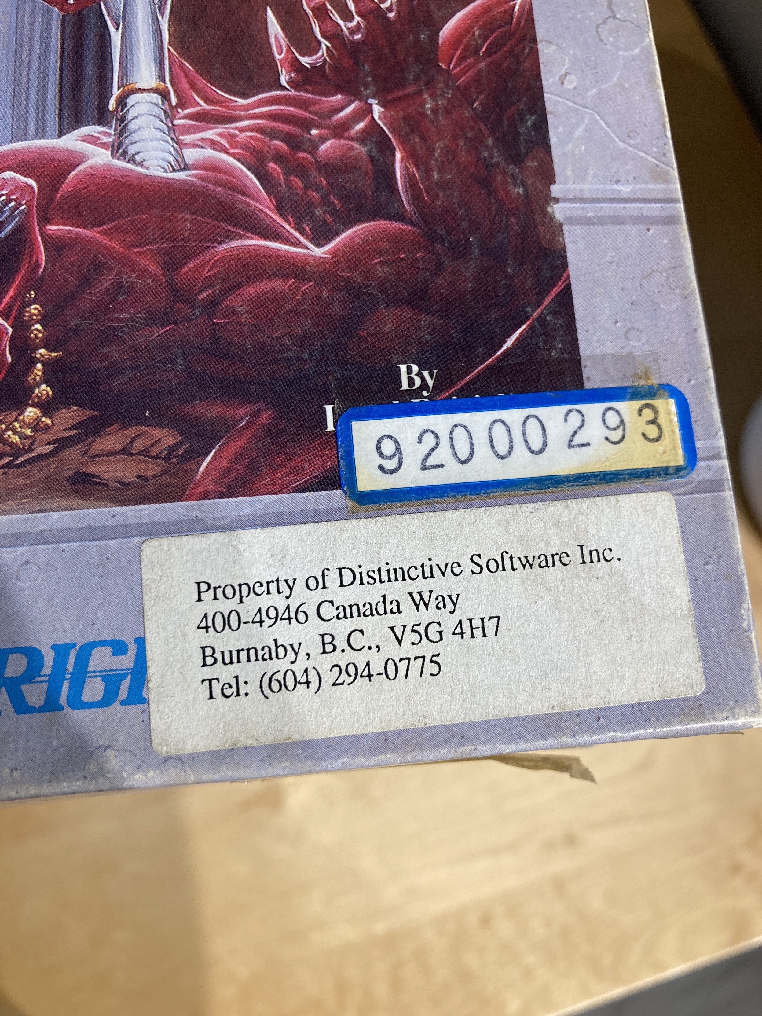 A Property of Distinctive Software label, stuck on the corner of the Ultima VI box.  It is given a serial number for its library.